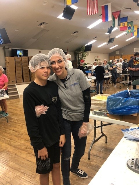 Jill and son feeding the kids event