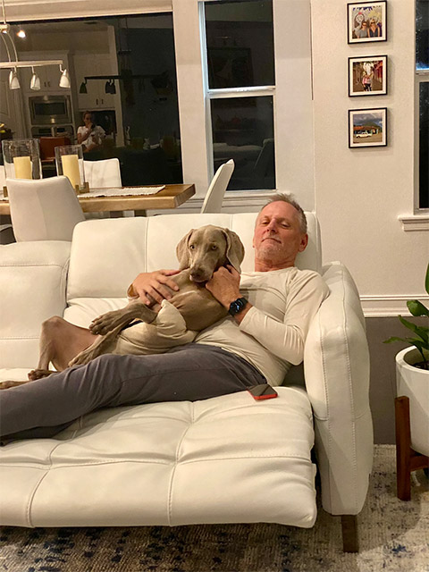 David relaxing with dog on couch